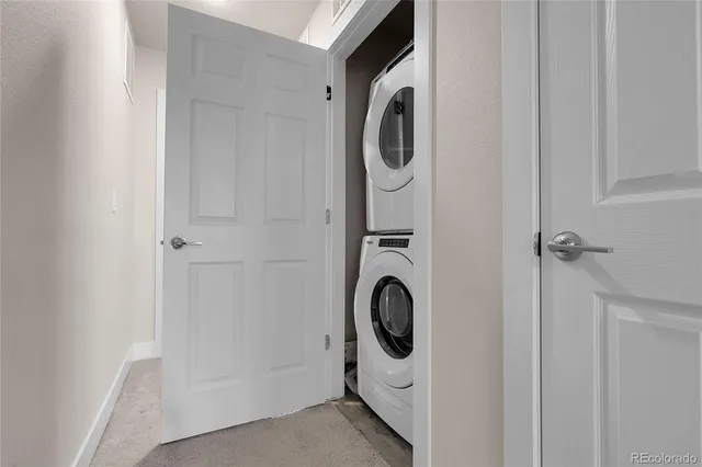 an empty room with a large window and ceiling fan