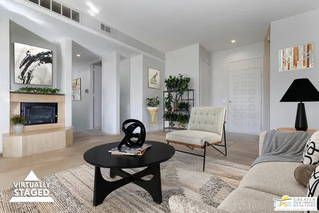 a living room with furniture a rug and a fireplace