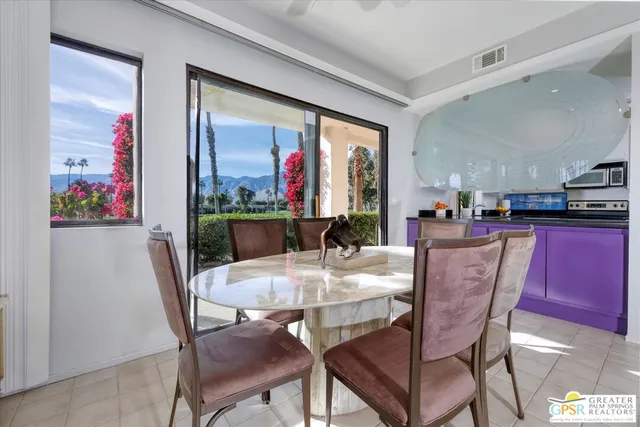 a dining room with furniture and window