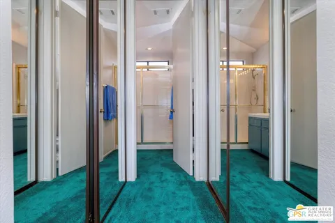 a bathroom with a granite countertop sink a toilet and a mirror