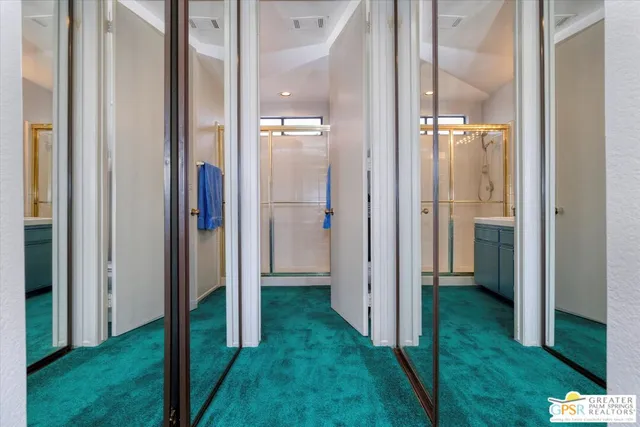 a bathroom with a double vanity sink mirror and shower