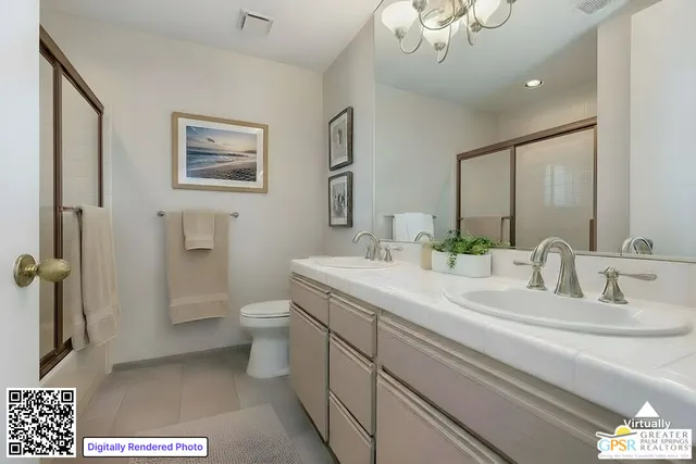 a bathroom with a granite countertop sink a toilet and a mirror