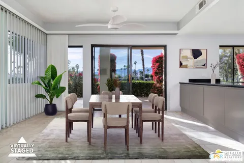 a dining room with furniture window and wooden floor