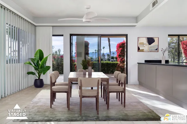a dining room with furniture window and wooden floor