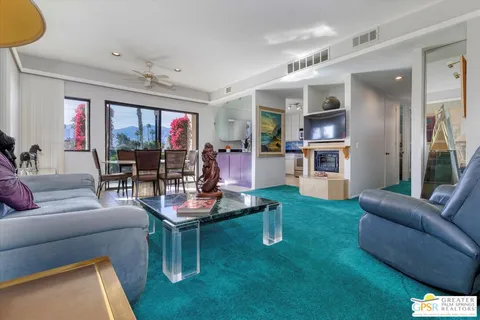 a living room with fireplace furniture and a flat screen tv