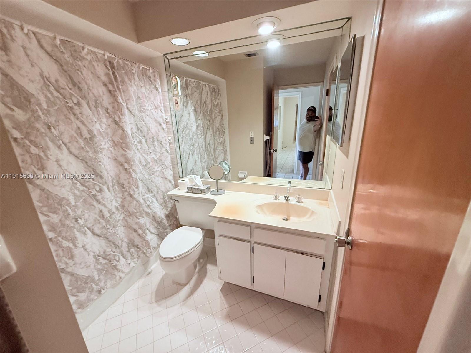 6225 Southwest 136th Court, Unit C209 Miami, FL 33183 - Photo 6 of 13 a bathroom with a sink toilet and shower