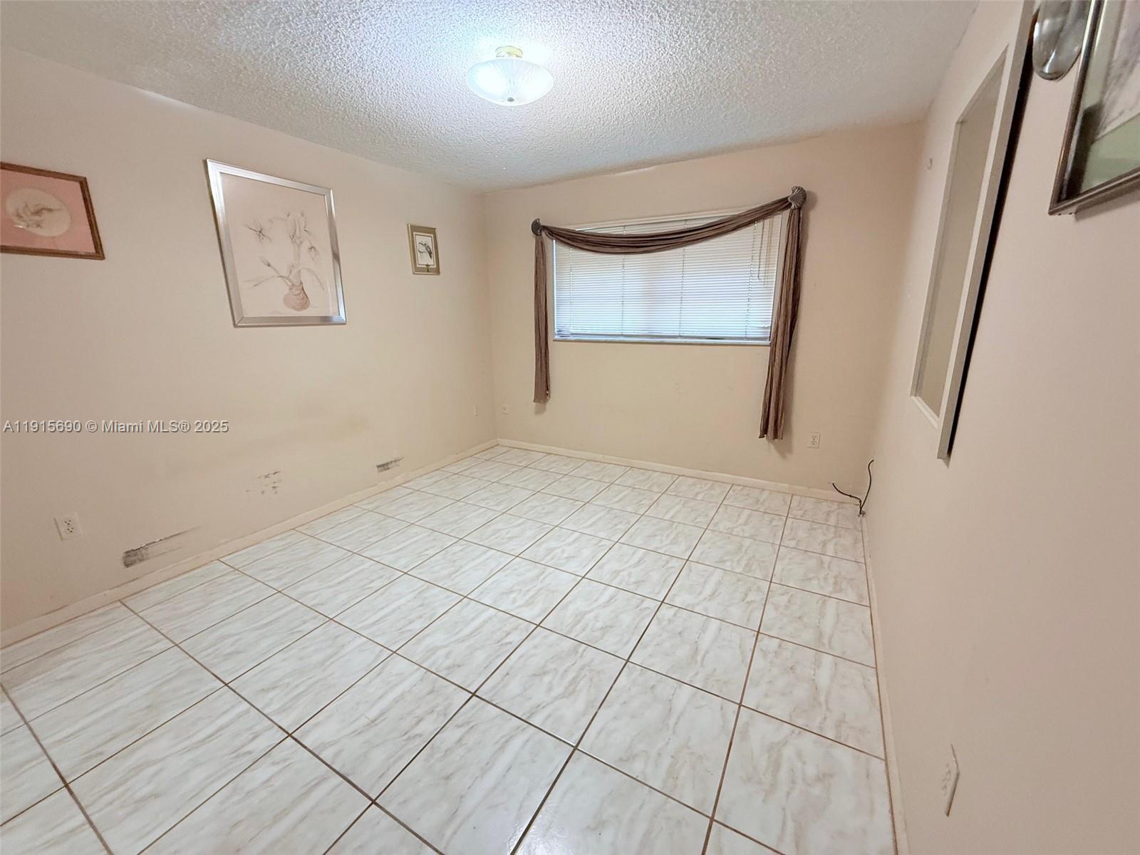 6225 Southwest 136th Court, Unit C209 Miami, FL 33183 - Photo 9 of 13 an empty room with windows and closet