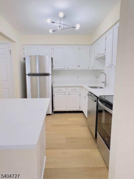 27 Alexandria Way, Unit 27 Bernards, NJ 07920 - Photo 8 of 19 a kitchen with granite countertop a sink a stove and cabinets