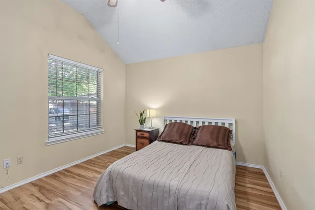 a bedroom with a bed and wooden floor