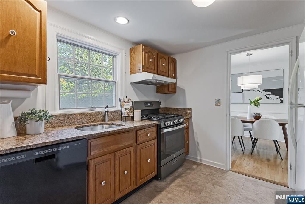 687 Grove Street Montclair, NJ 07043 - Photo 7 of 18 a kitchen with a sink stove and cabinets