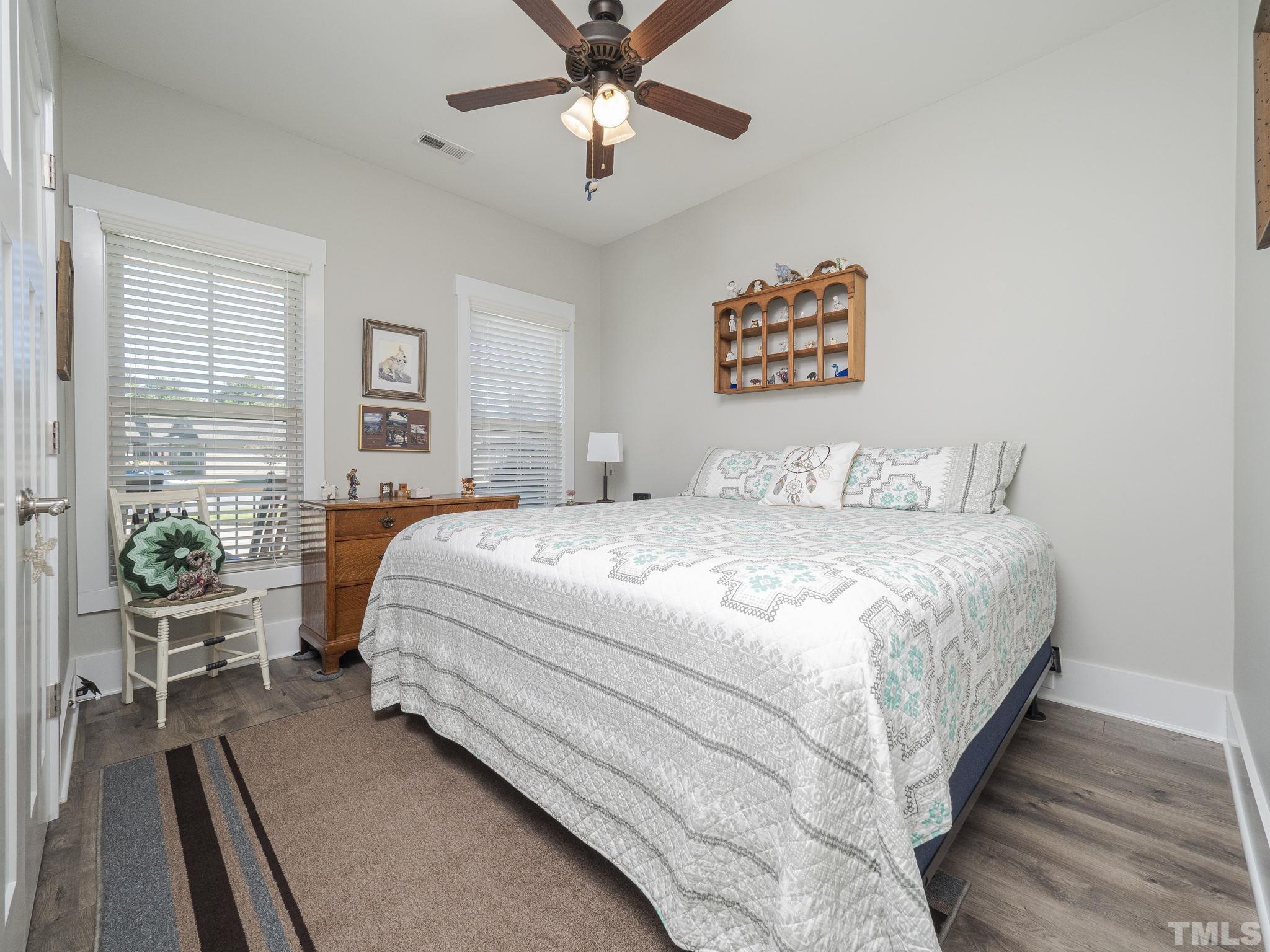 137 Bella Square Smithfield, NC 27577 - Photo 14 of 29 a bedroom with a large bed and a chandelier
