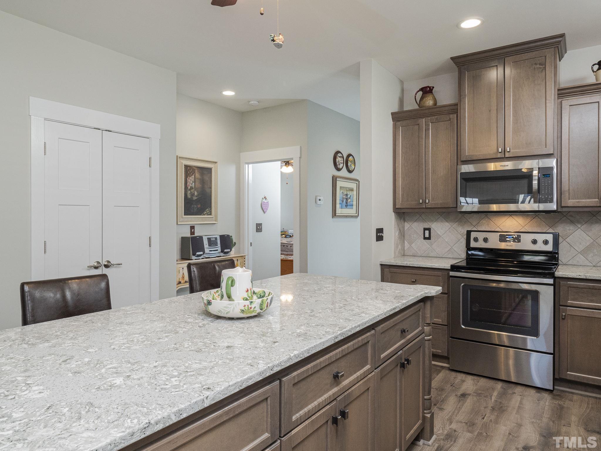 137 Bella Square Smithfield, NC 27577 - Photo 3 of 29 a kitchen with stainless steel appliances granite countertop a stove refrigerator and sink