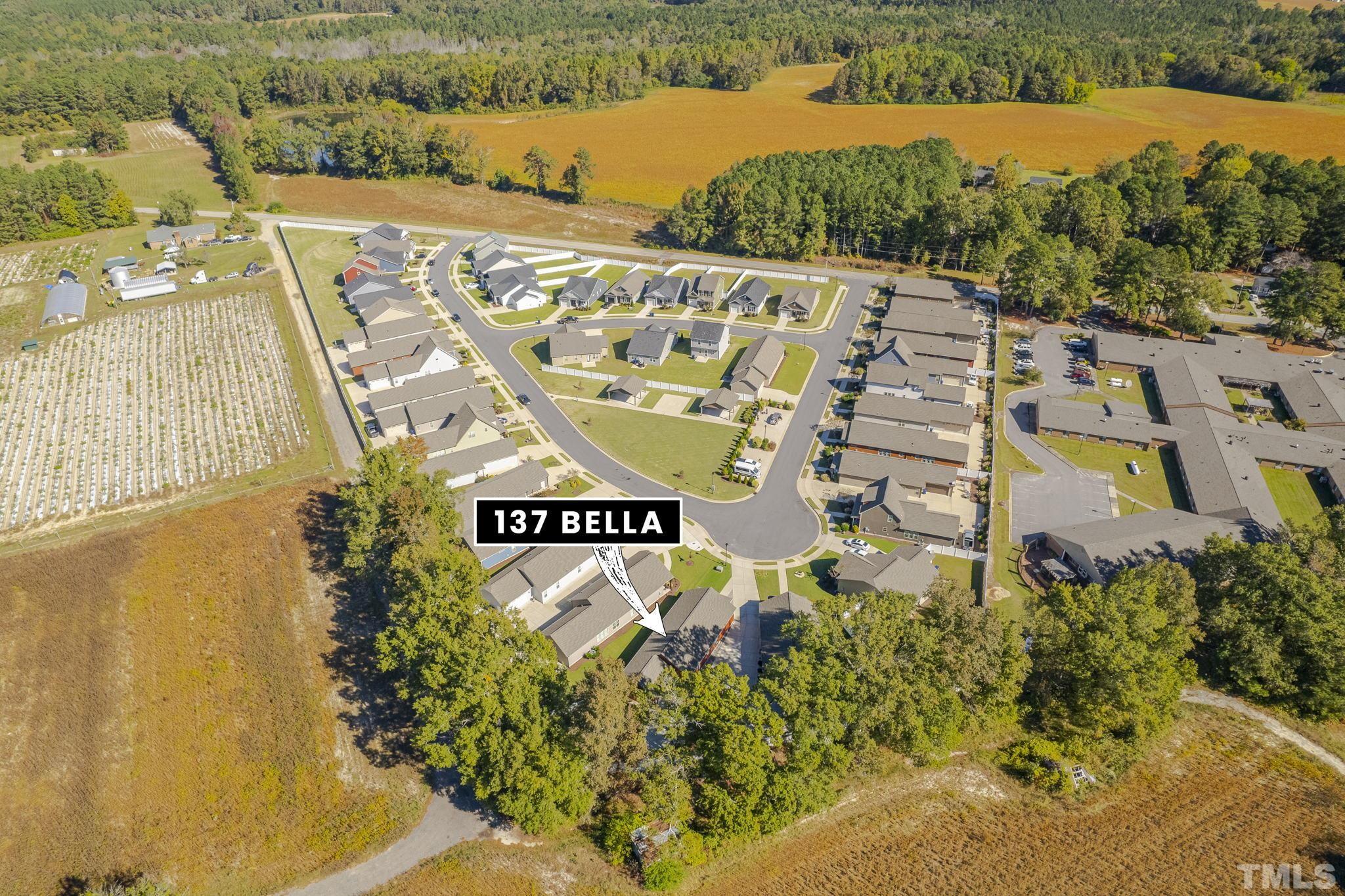 137 Bella Square Smithfield, NC 27577 - Photo 27 of 29 a sign that is sitting on a brick wall with a lake view