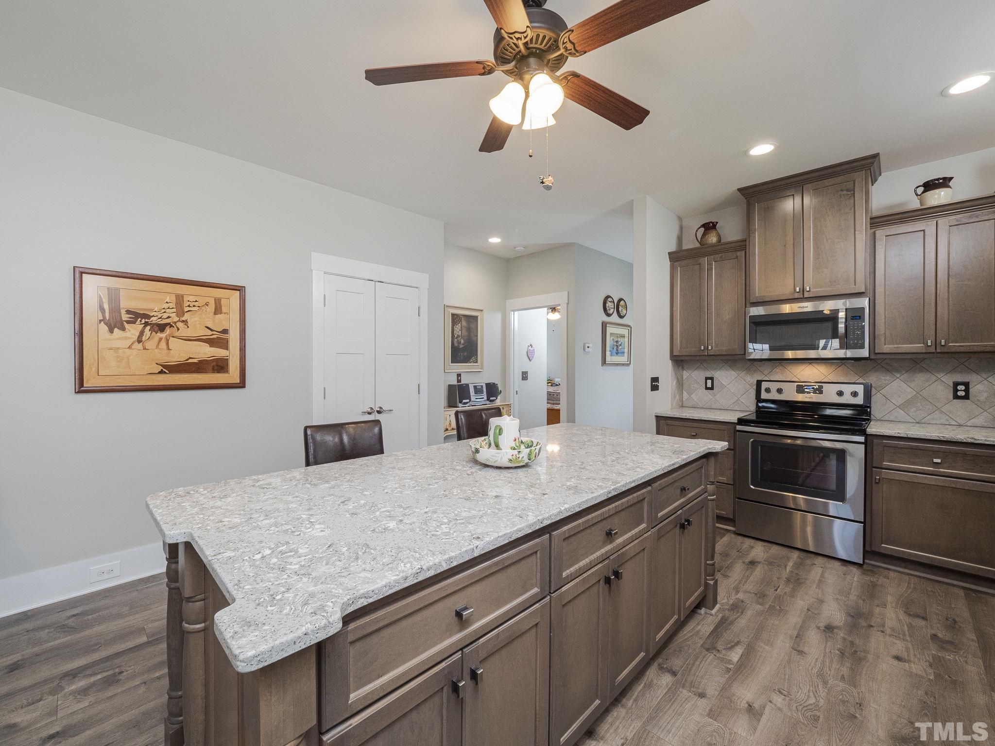 137 Bella Square Smithfield, NC 27577 - Photo 6 of 29 a kitchen with stainless steel appliances granite countertop a sink dishwasher stove and refrigerator