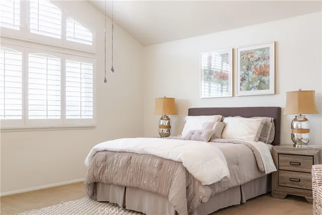 a view of a swimming pool with a yard and palm trees