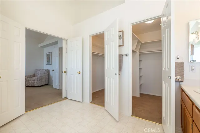 a view of swimming pool with outdoor seating and trees in the background