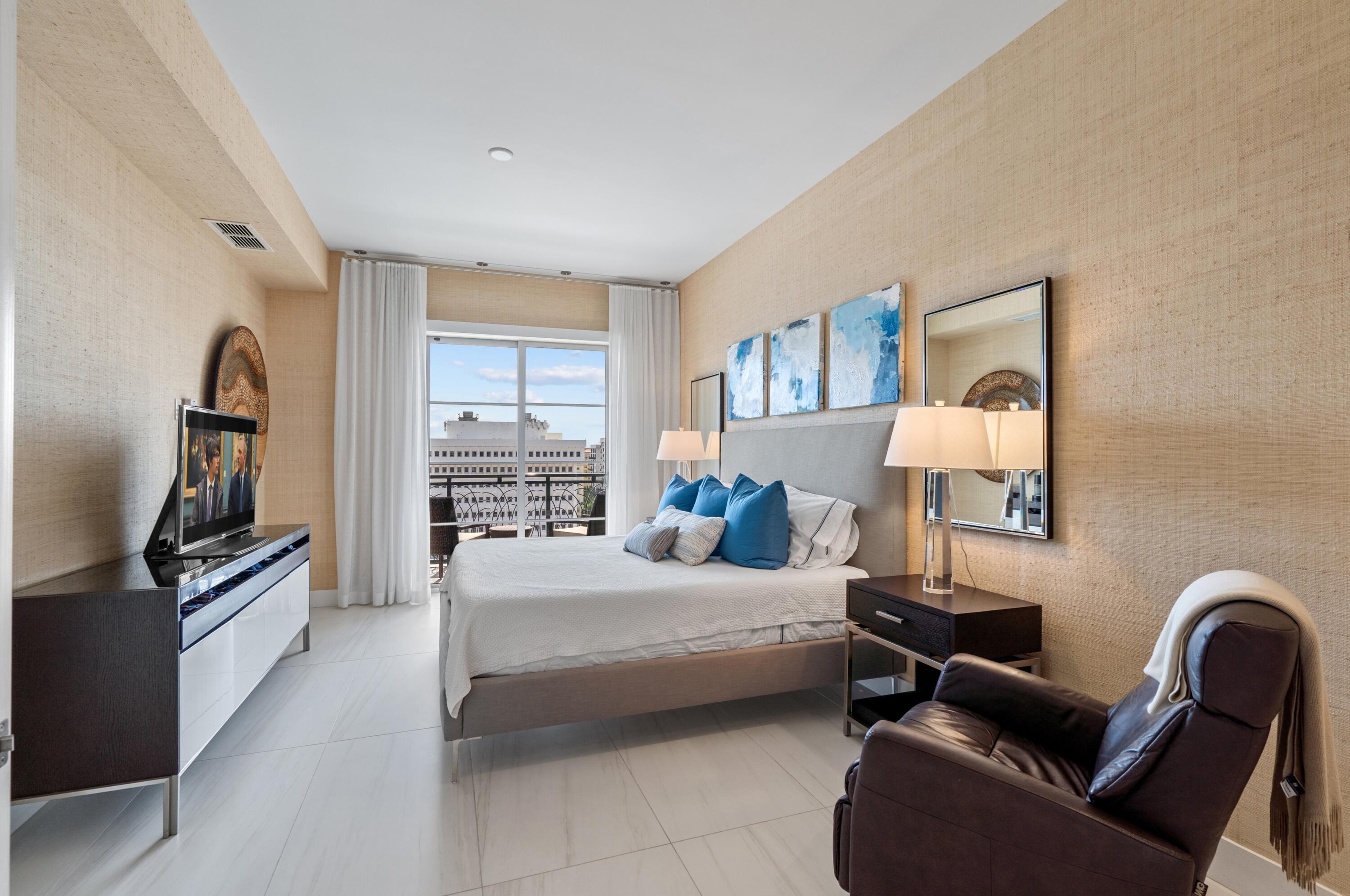 155 East Boca Raton Road, Unit 1010 Boca Raton, FL 33432 - Photo 14 of 27 a bedroom with bed couch and window