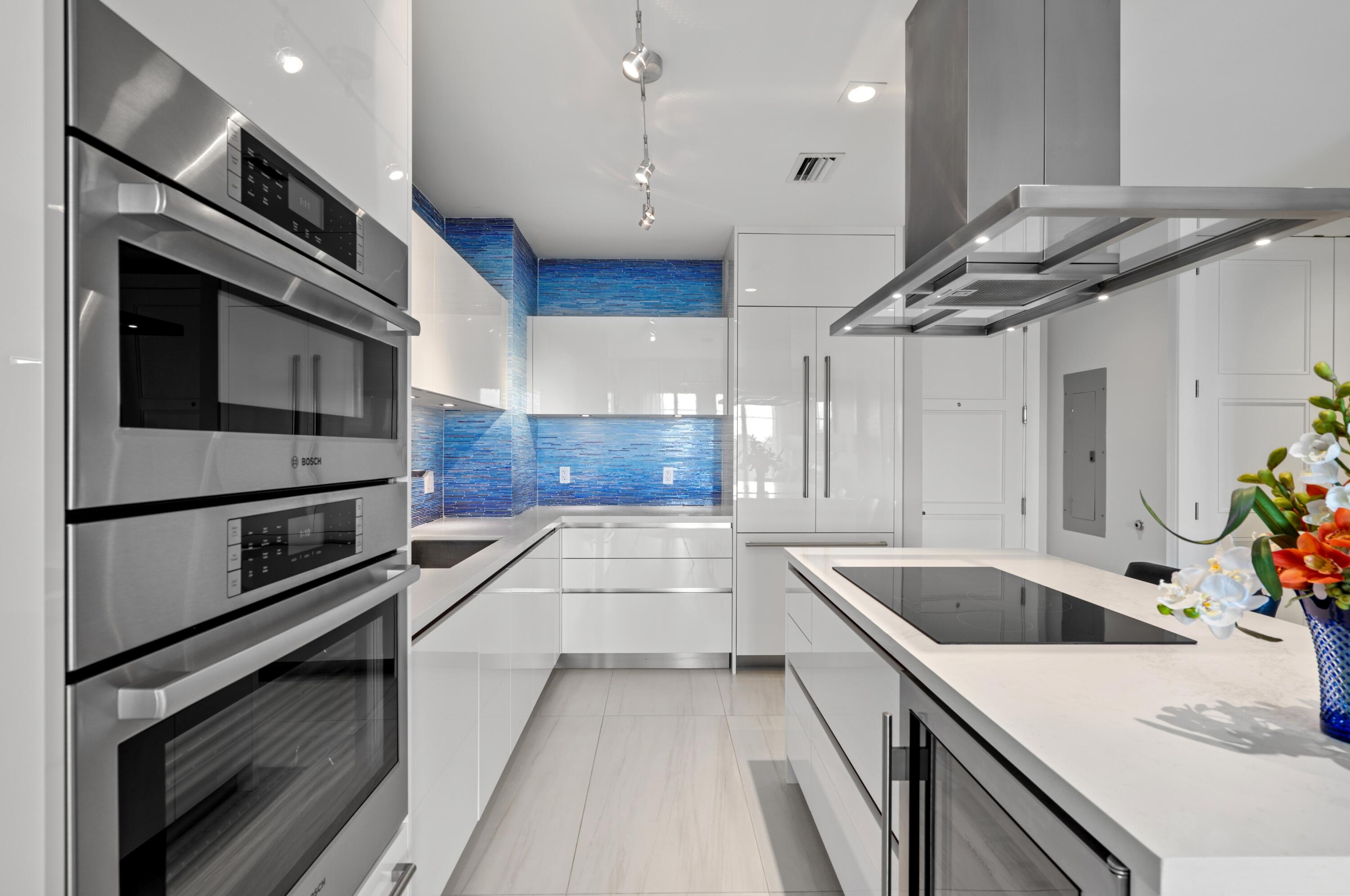 155 East Boca Raton Road, Unit 1010 Boca Raton, FL 33432 - Photo 7 of 27 a kitchen with stainless steel appliances kitchen island granite countertop a stove and a sink