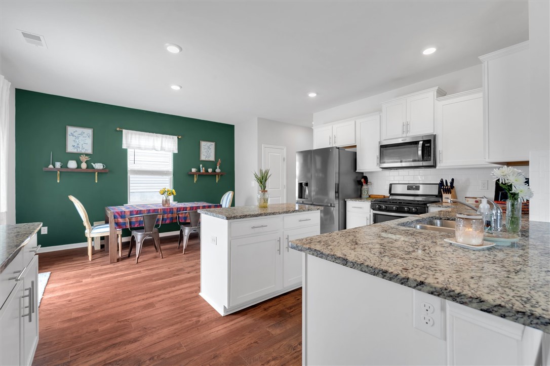191 Light Spring Road Easley, SC 29642 - Photo 12 of 34 This kitchen and dining area provides a seamless blend of everyday functionality and entertaining space.