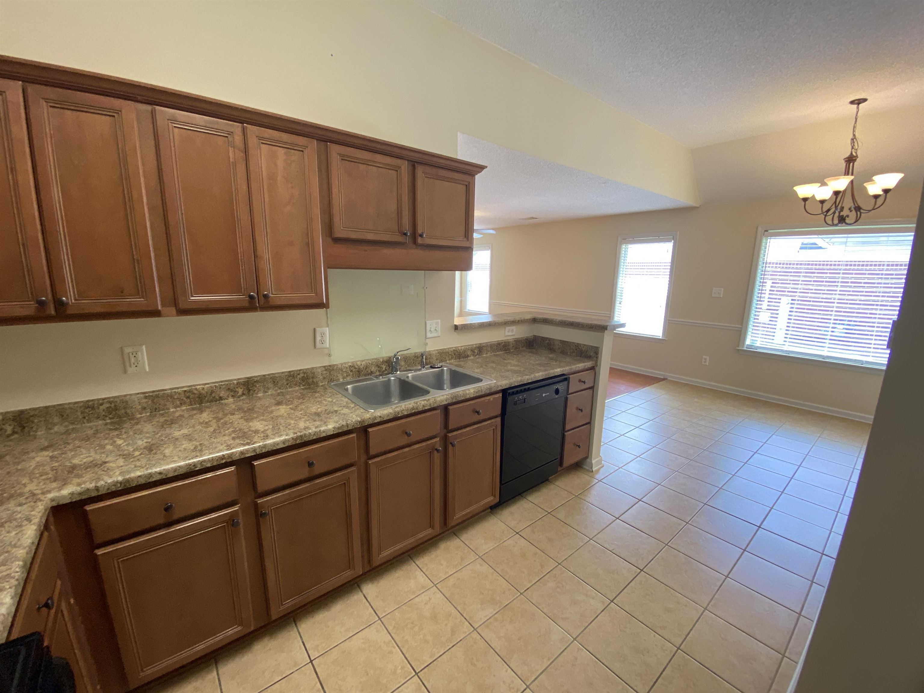 1299 Appling Road Cordova, TN 38016 - Photo 7 of 21 a large kitchen with granite countertop a sink a stove cabinets and wooden floor