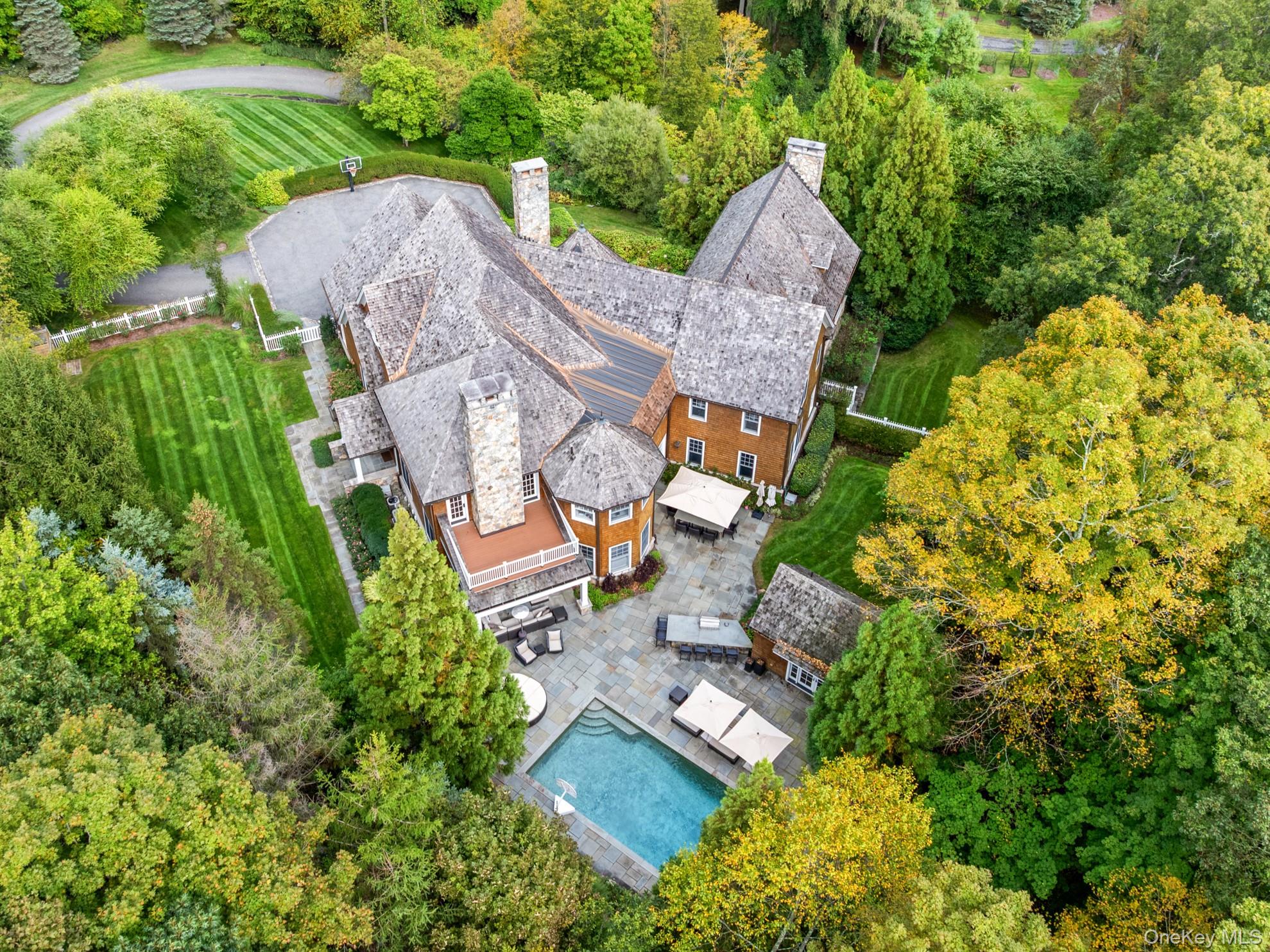 an aerial view of a house with a garden and trees