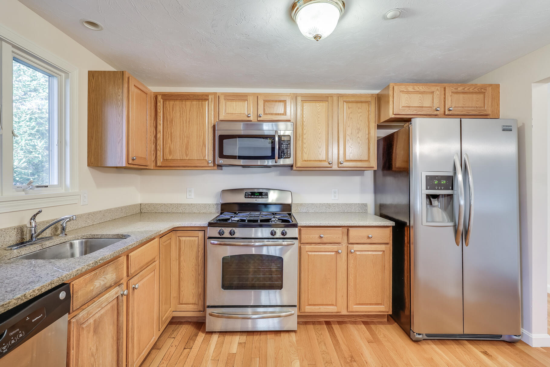 16 North Ridge Road Mashpee, MA 02649 - Photo 13 of 47 a kitchen with a stove a sink and a refrigerator