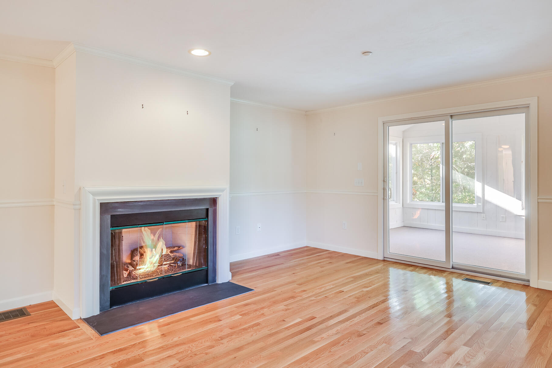16 North Ridge Road Mashpee, MA 02649 - Photo 20 of 47 an empty room with wooden floor fireplace and windows