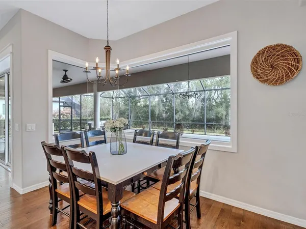 a kitchen with stainless steel appliances granite countertop a sink a stove and a wooden floors