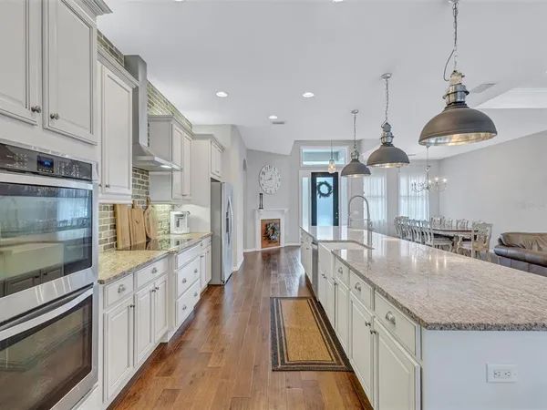 a kitchen with sink stove and refrigerator