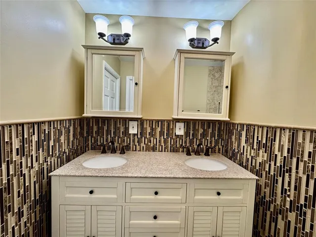 a bathroom with a sink a mirror and shower