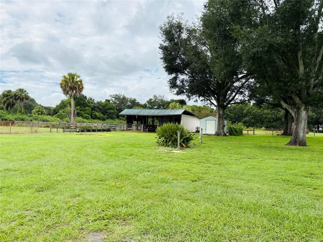 a view of yard with swimming pool and green space