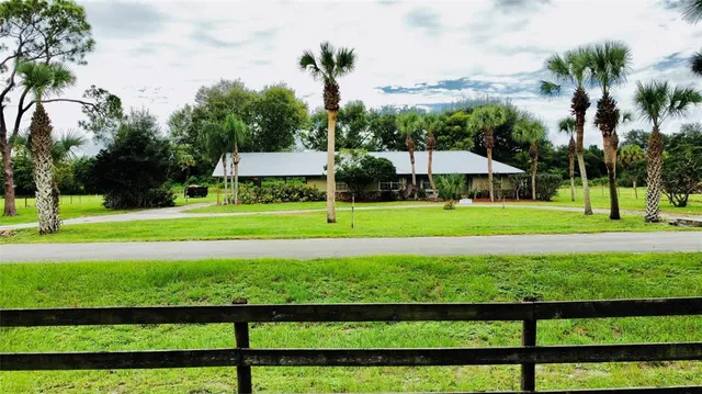 a view of a swimming pool with a yard and a trampoline