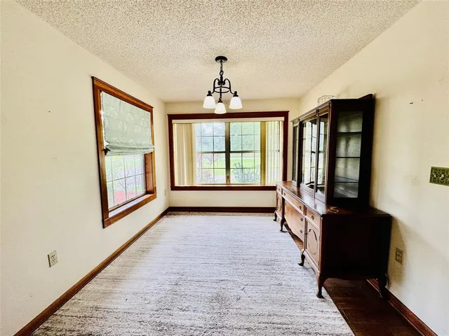 a large kitchen with kitchen island a sink stainless steel appliances and cabinets
