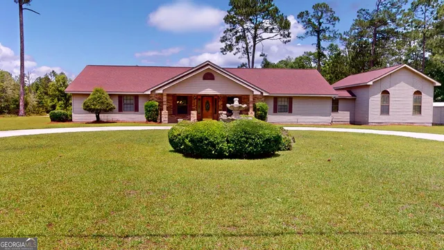 a front view of a house with yard