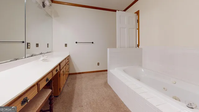 a large kitchen with stainless steel appliances a sink and cabinets