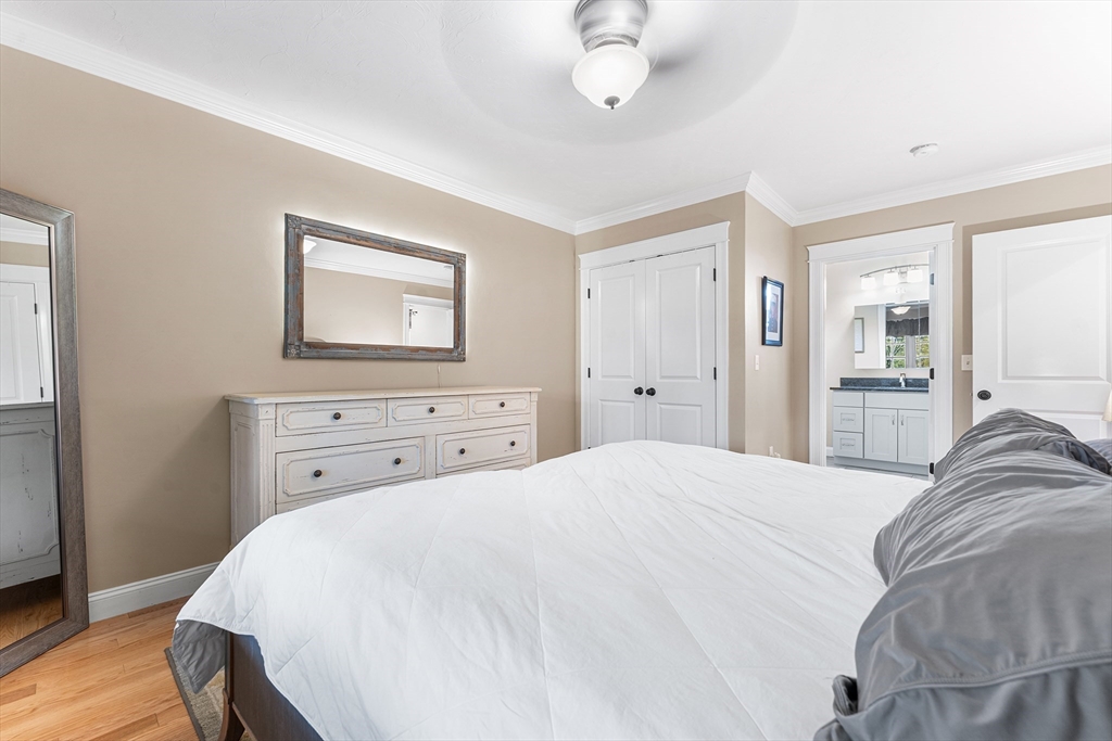 22 Washington Street Mendon, MA 01756 - Photo 13 of 31 a bedroom with a bed and a chandelier