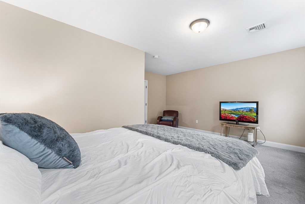 22 Washington Street Mendon, MA 01756 - Photo 17 of 31 a bedroom with a bed and a couch