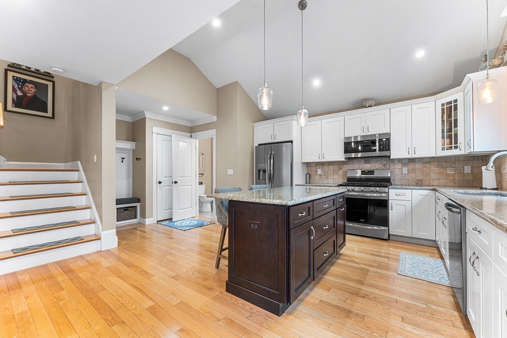 22 Washington Street Mendon, MA 01756 - Photo 7 of 31 a large kitchen with stainless steel appliances granite countertop a stove a sink and a refrigerator