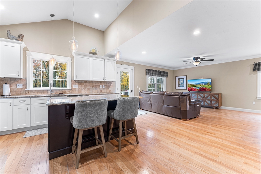 22 Washington Street Mendon, MA 01756 - Photo 9 of 31 a kitchen with a table chairs a sink dishwasher stove and cabinets with wooden floor