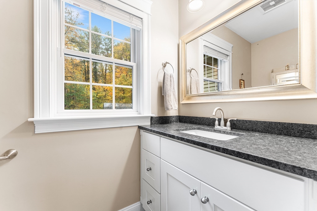 22 Washington Street Mendon, MA 01756 - Photo 10 of 31 a bathroom with a granite countertop sink and a window