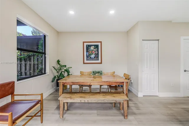 a dining room with furniture and window