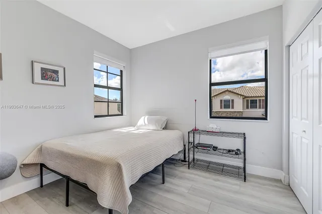 a bedroom with a bed and a painting on the wall