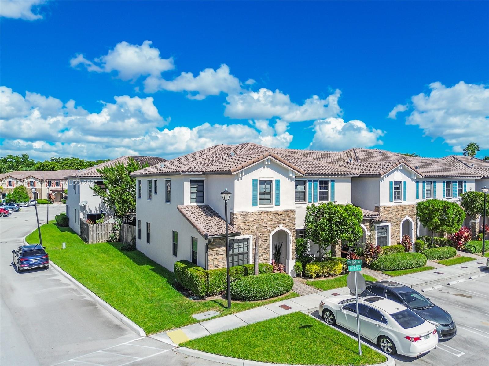 15097 Southwest 115th Street Miami, FL 33196 - Photo 2 of 44 a front view of a house with garden