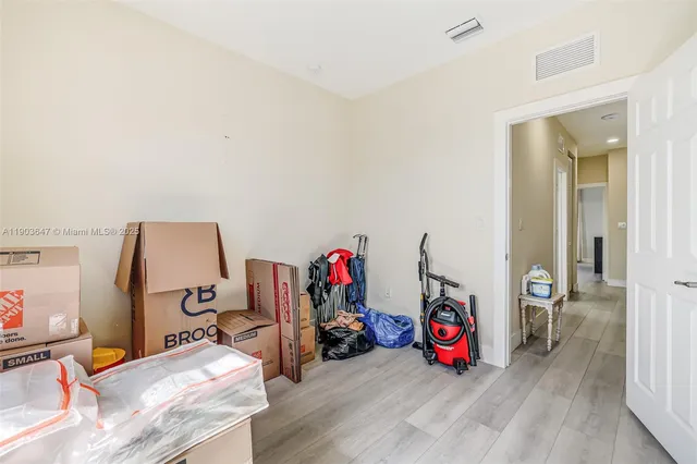 a view of a room with wooden floor and furniture