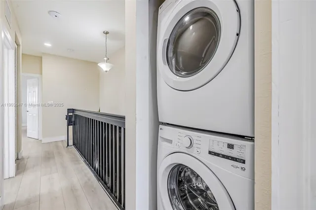 a view of a hallway with washer and dryer