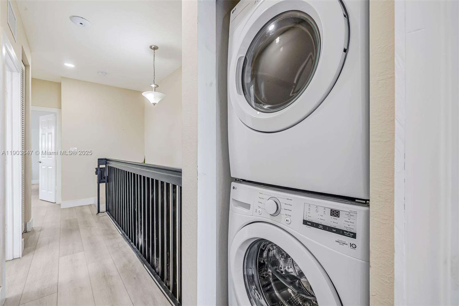 15097 Southwest 115th Street Miami, FL 33196 - Photo 31 of 44 a view of a hallway with washer and dryer