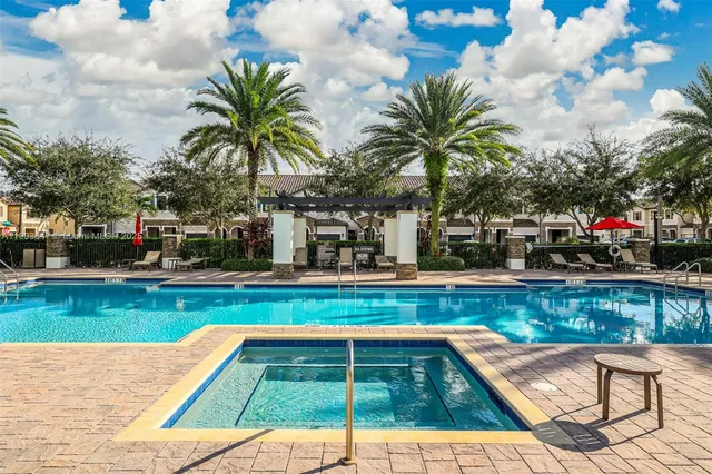 a view of swimming pool with sitting area