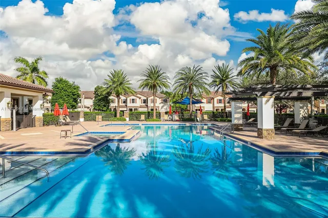 a view of a house with swimming pool and a yard