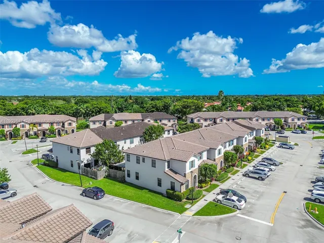 an aerial view of a house with a big yard