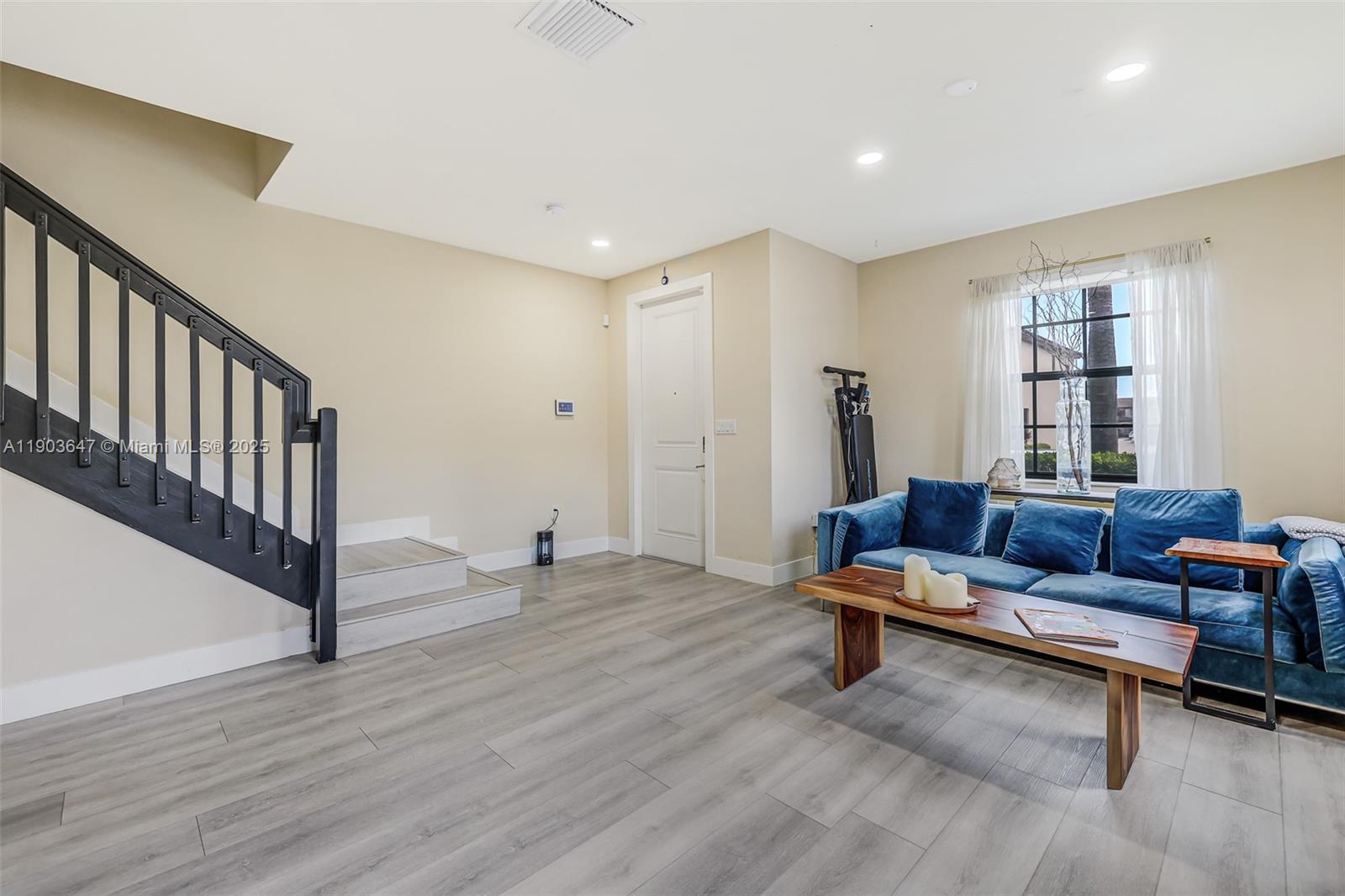 15097 Southwest 115th Street Miami, FL 33196 - Photo 6 of 44 a living room with furniture and a wooden floor